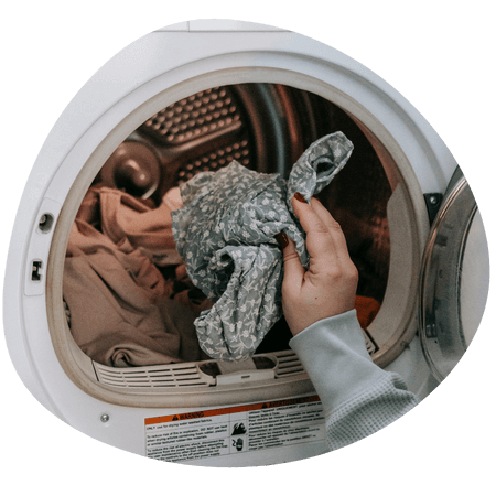 person loading a washing machine