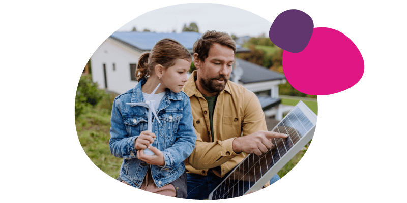 father and daughter looking at solar panels