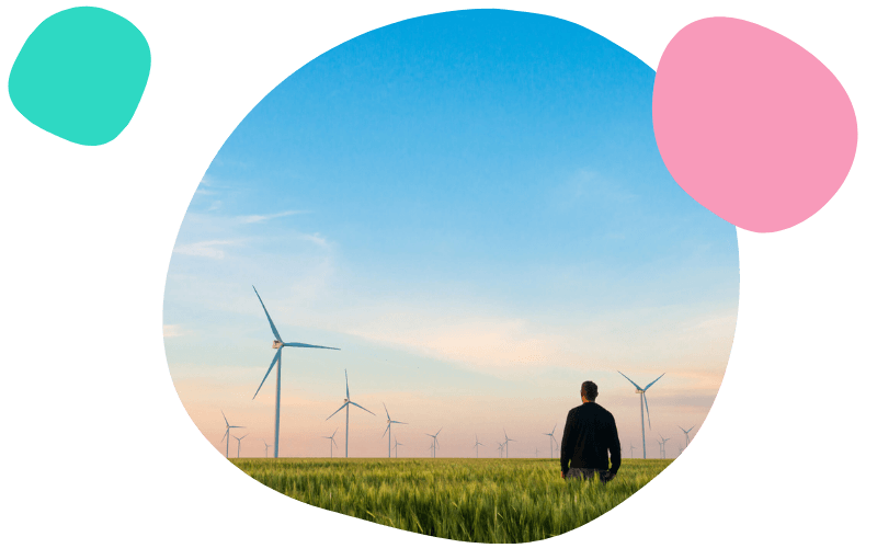 man stood looking at a wind farm