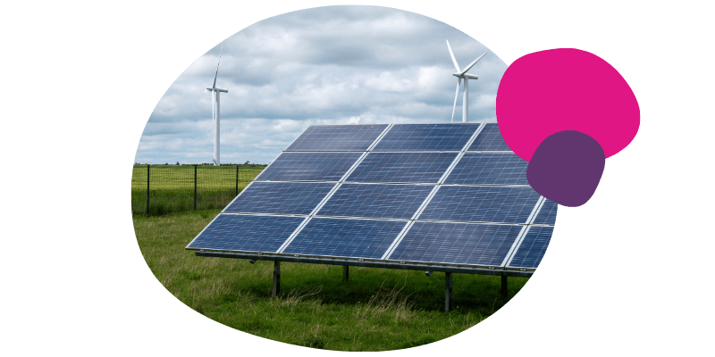 solar panels with wind turbines in the background