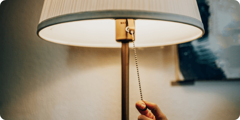 person turning off a lamp