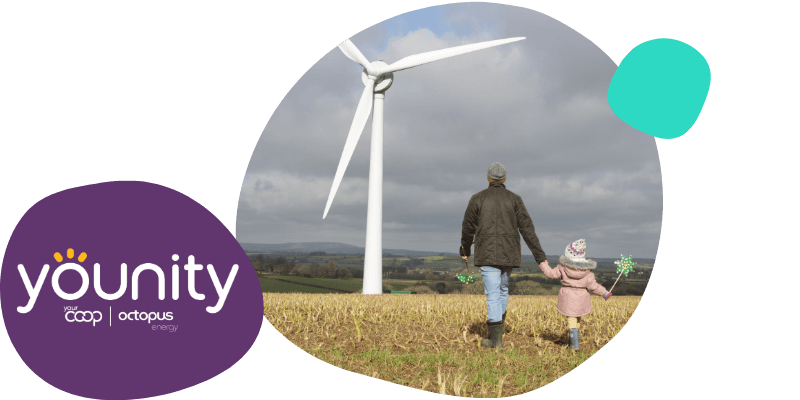 father and daughter holding hands infront of a wind turbine