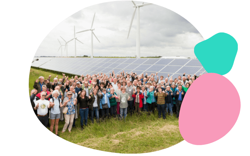 energy project group stood infront of solar panels and wind turbines