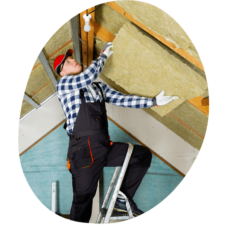 man installing insulation in loft