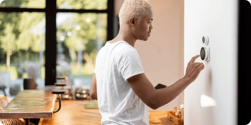 man lowering his home temperature