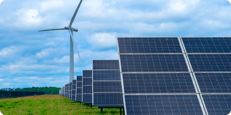 solar panels and wind turbine in the field