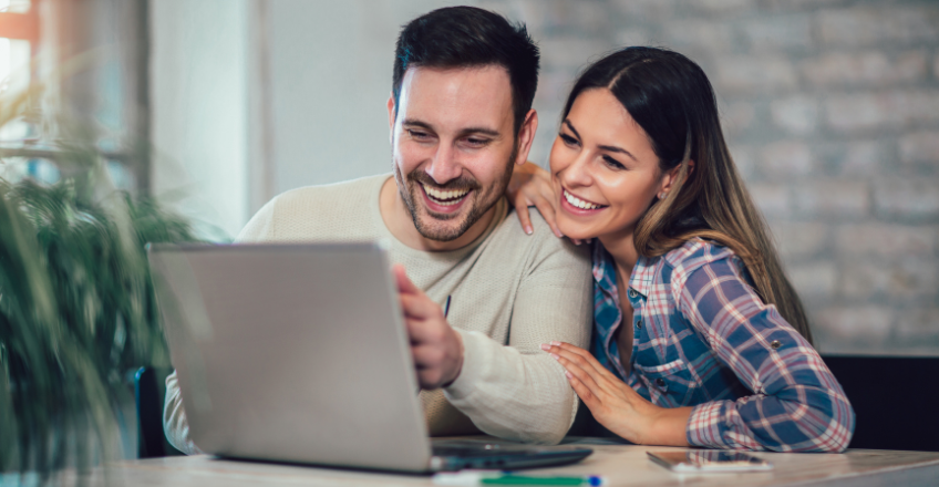 young couple looking at a computer