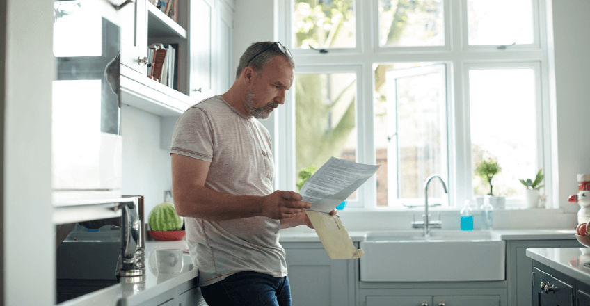 man reading his energy bill