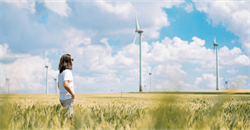 man staring at wind turbines